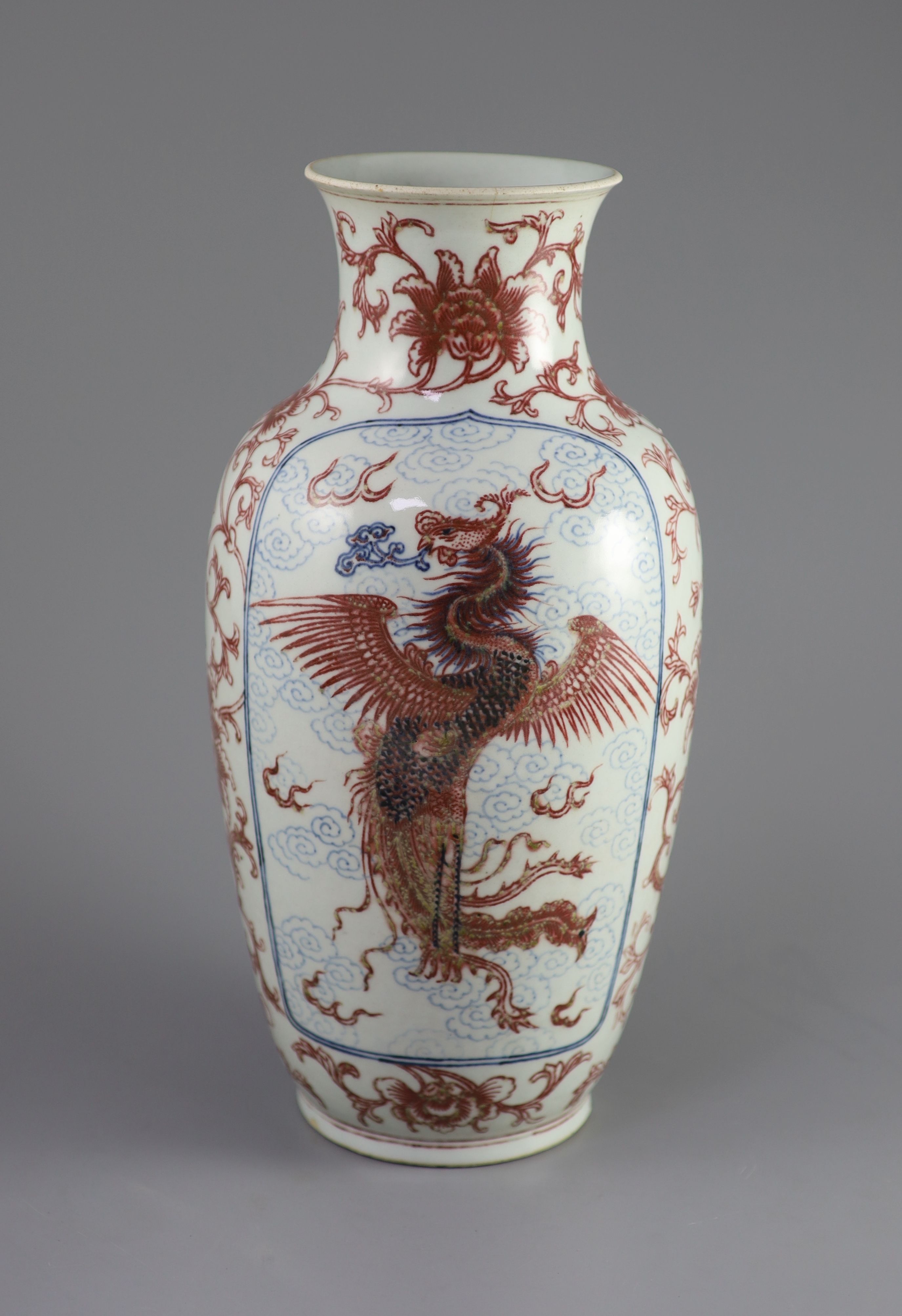 A Chinese underglaze blue and copper red 'dragon and phoenix' vase, Daoguang period (1821-50), 36cm high, rim ground off